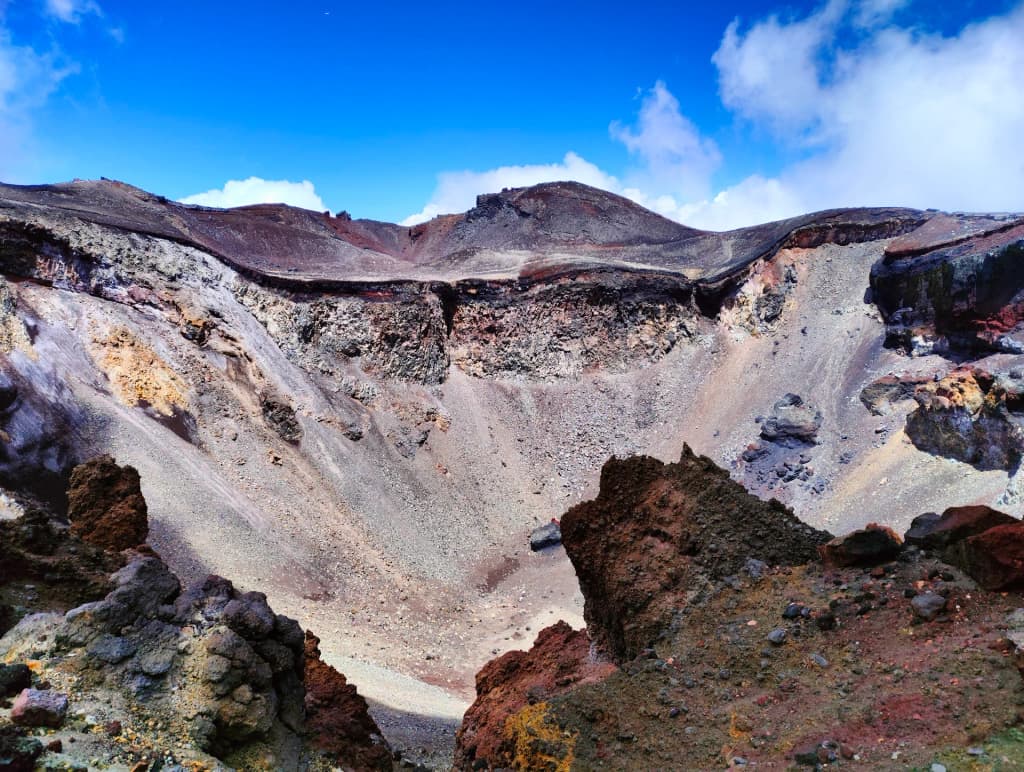 A rare, snowless Mount Fuji visible through the summer haze from the airplane window