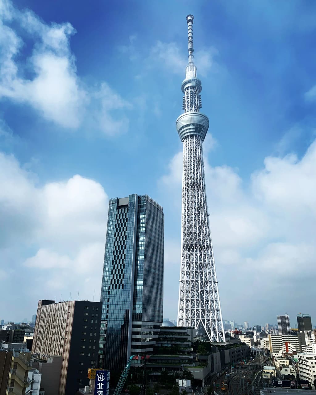 The towering Tokyo Skytree rising above the dense, sprawling metropolis at dusk