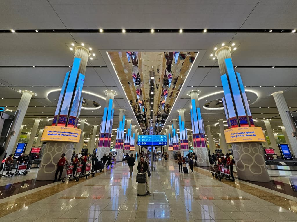 The sweeping architecture and bright lights of Dubai International Airport during a layover