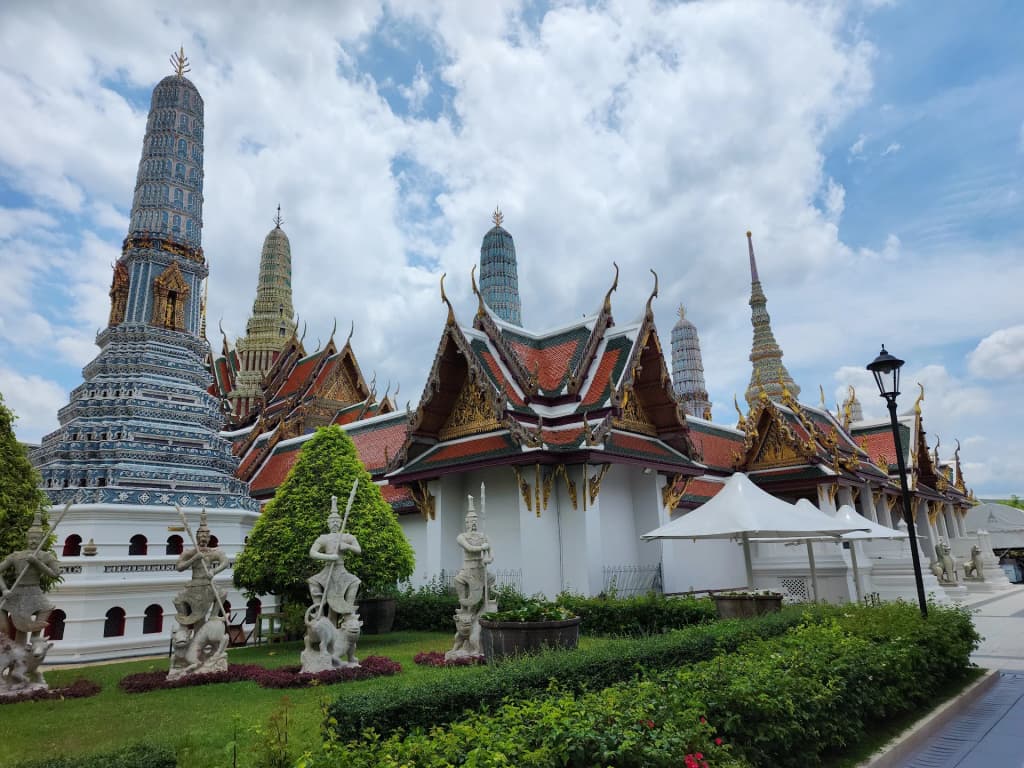 Golden spires of the Grand Palace gleaming against the Bangkok sky