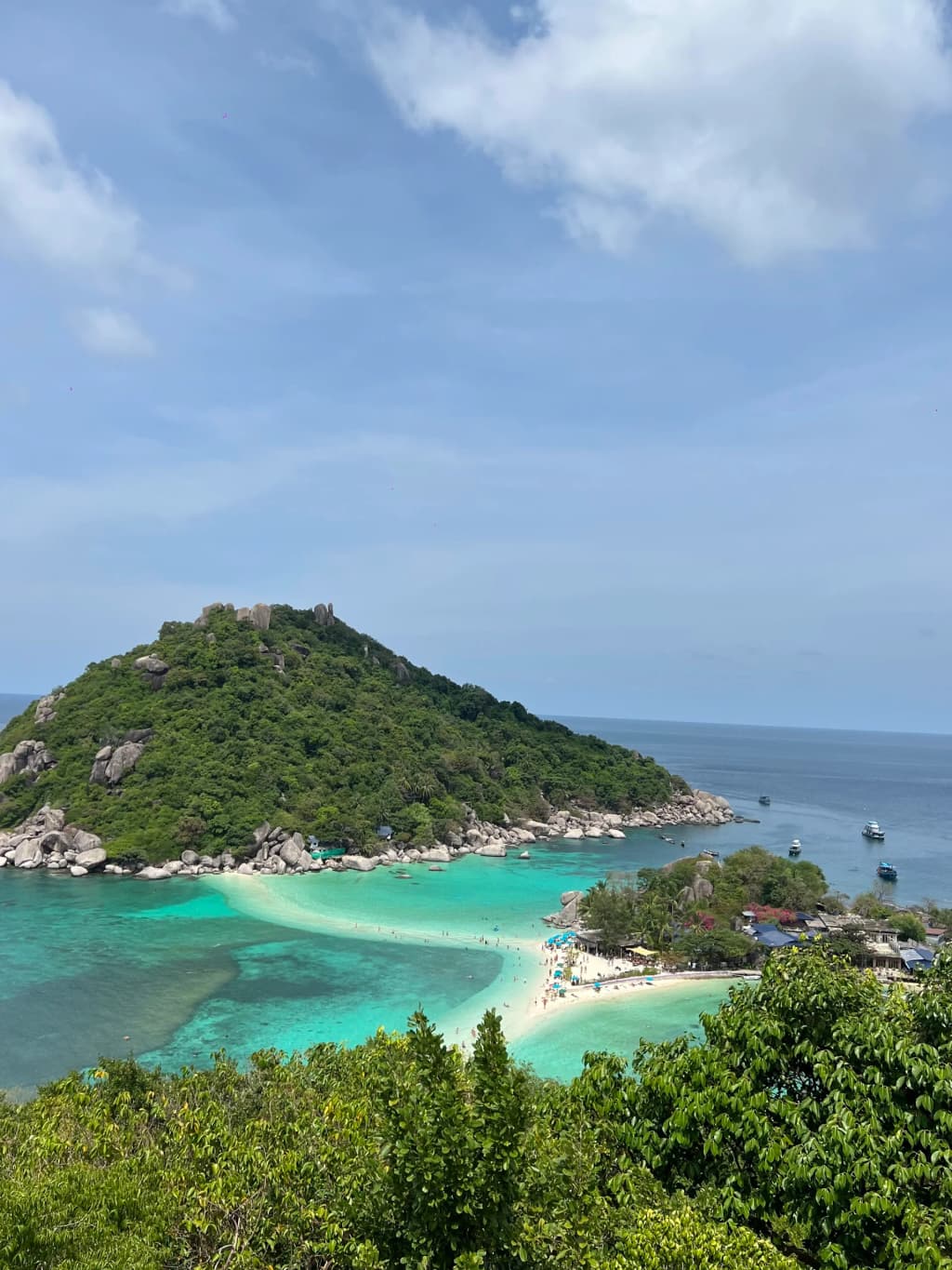 Longtail boats resting on the clear waters of Koh Tao
