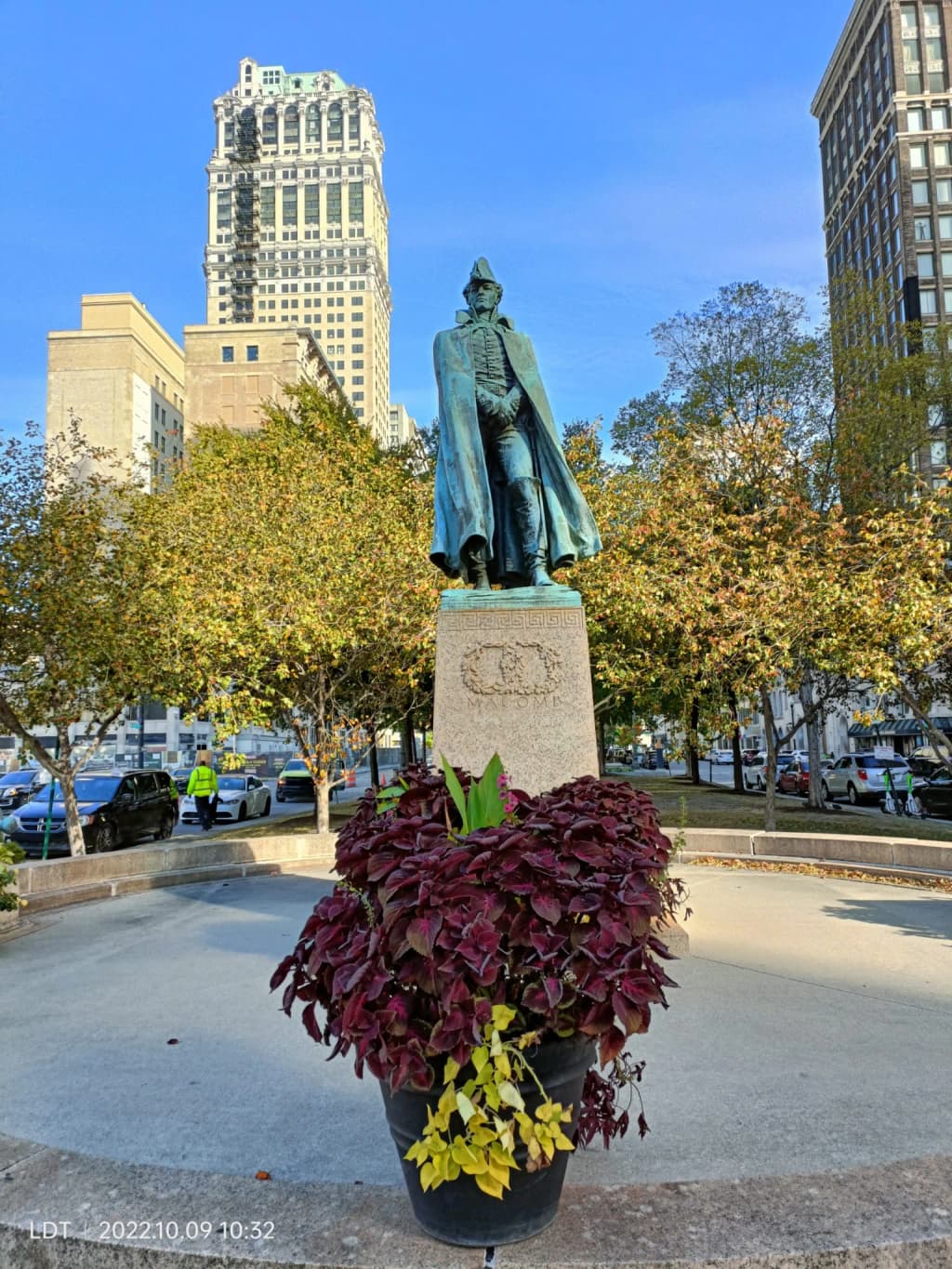 A lively street view in downtown Detroit showcasing its historic Art Deco architecture