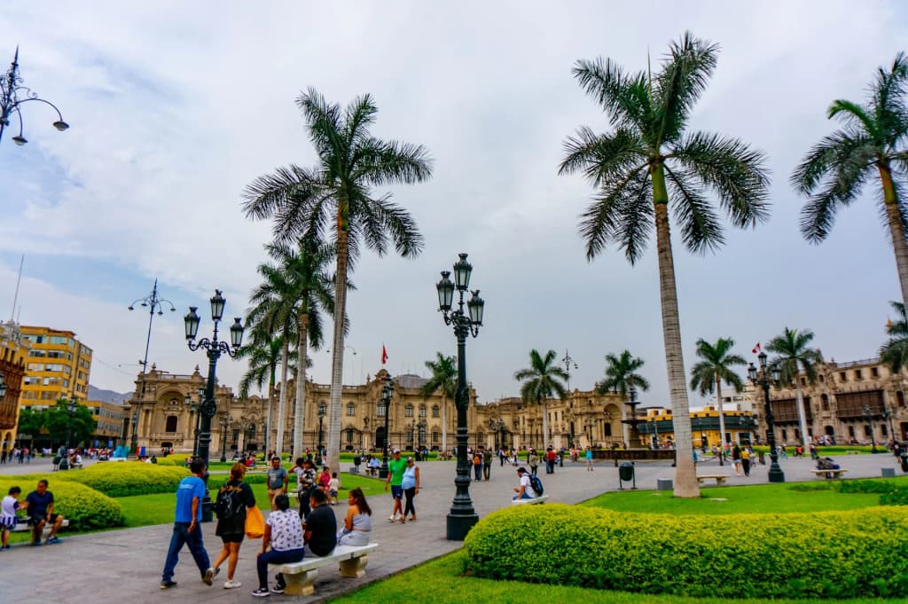 The historic colonial architecture of Lima's Main Square under a gray sky