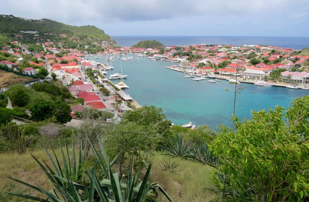 The red roofs and luxury yachts anchored in the pristine harbor of Gustavia