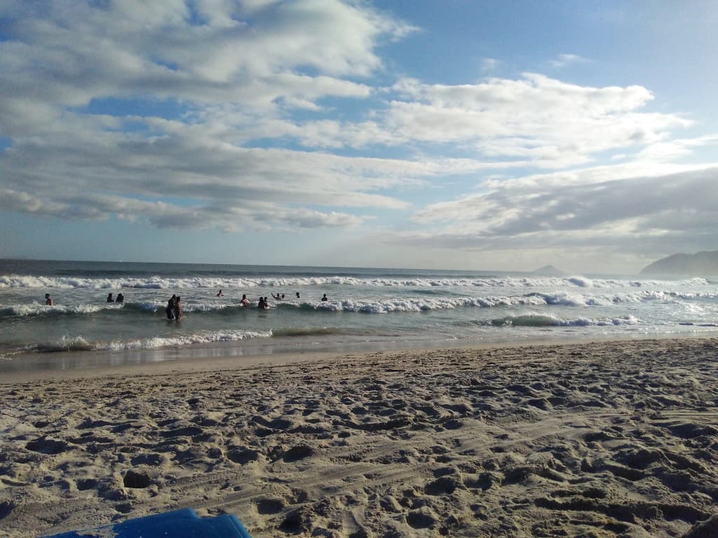Surfers and sunbathers enjoying the consistent waves at Maresias Beach