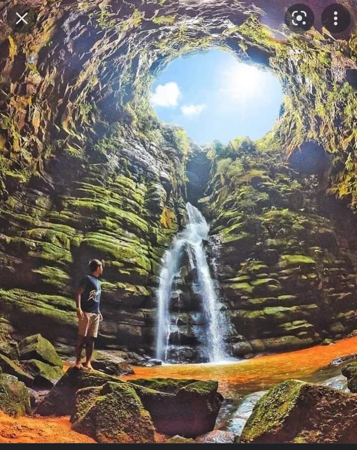 The lush entrance to Buraco do Padre, sunlight streaming through trees