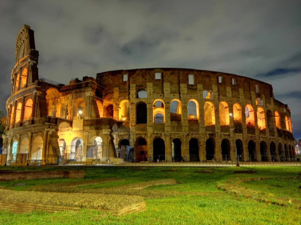 Morning sunlight hitting the ancient arches of the Colosseum in Rome