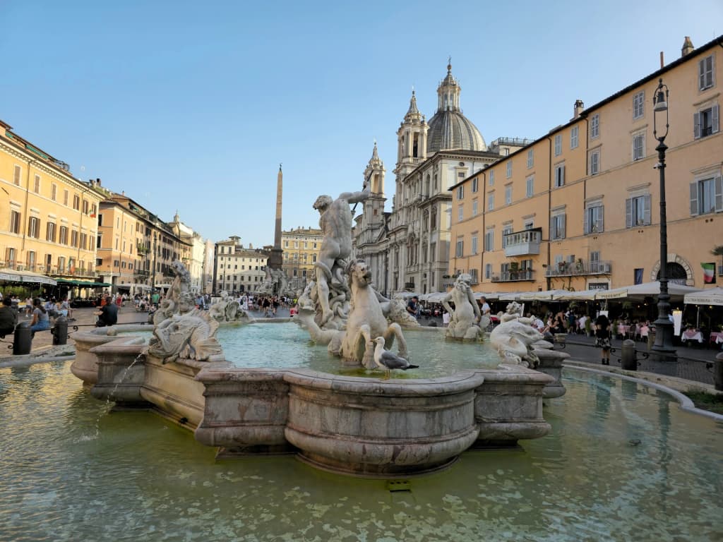 Piazza Navona fountain at dusk with historic architecture