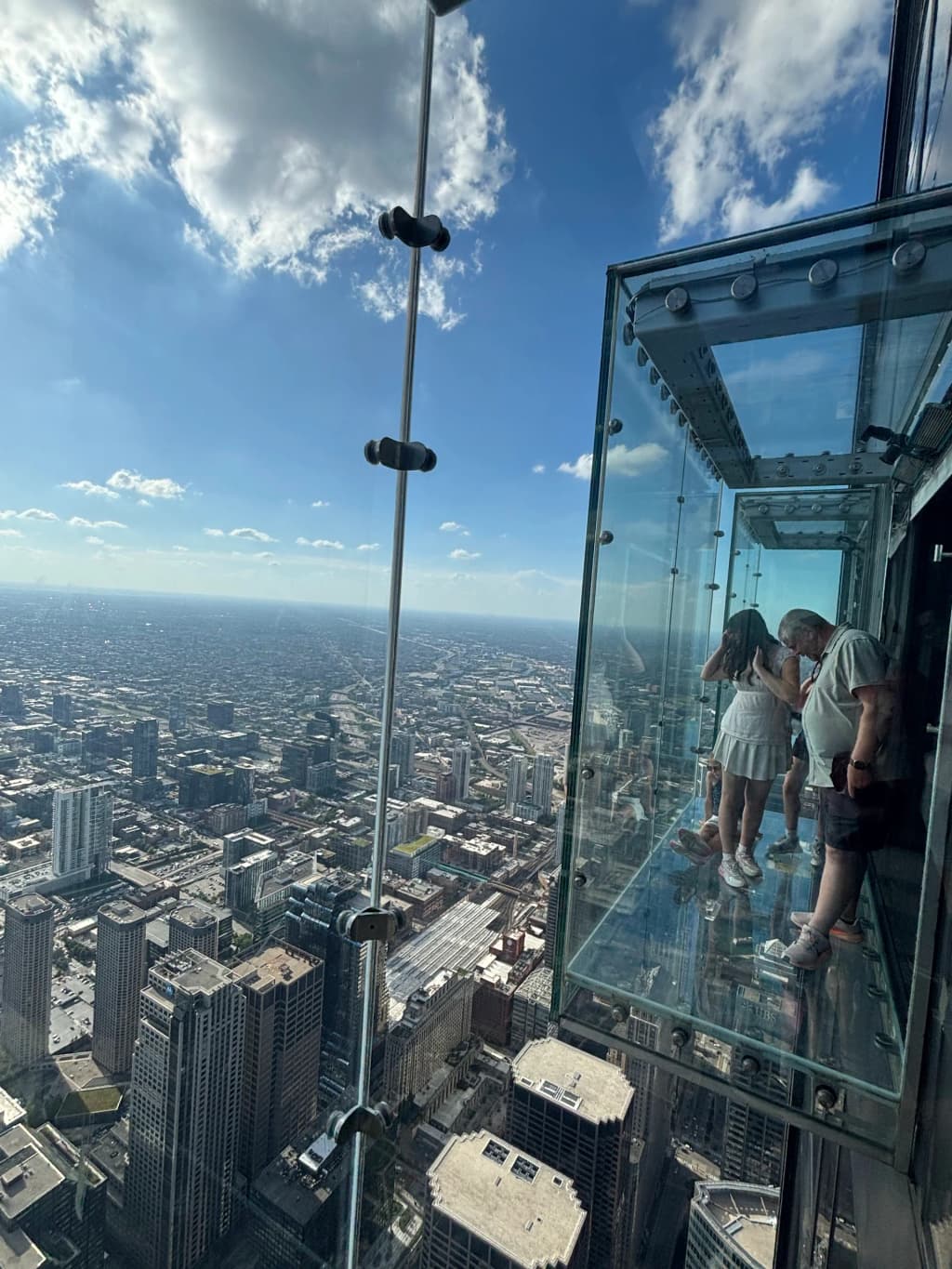 Looking down through the glass floor of the Skydeck at the Chicago grid