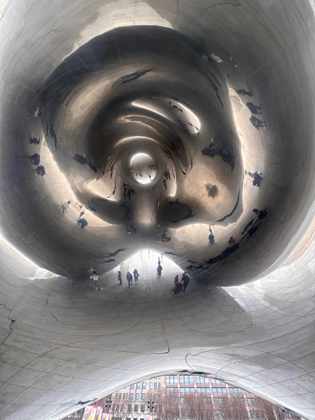 The silver reflection of the city skyline in Cloud Gate at Millennium Park