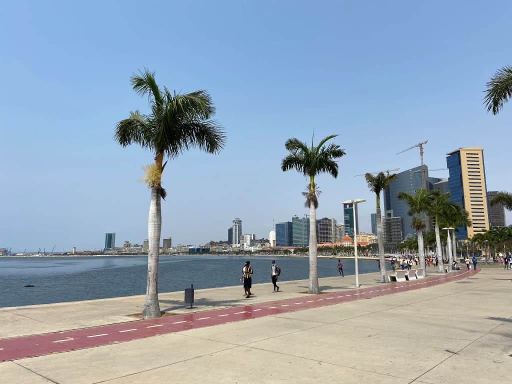 The sweeping crescent of the Luanda Bay Waterfront at dusk
