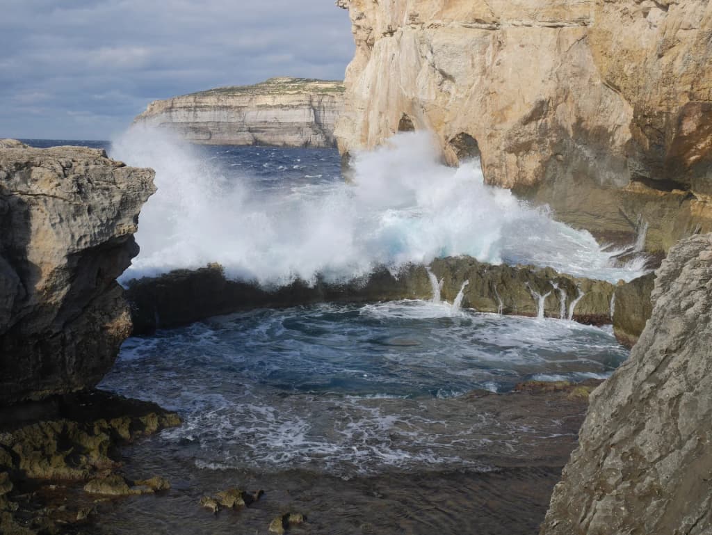 Swimmers exploring the deep waters of the Blue Hole on Gozo