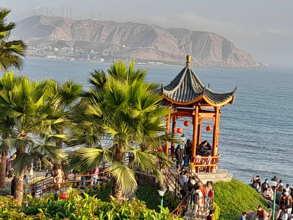 Paragliders soaring over the coastal cliffs of Miraflores