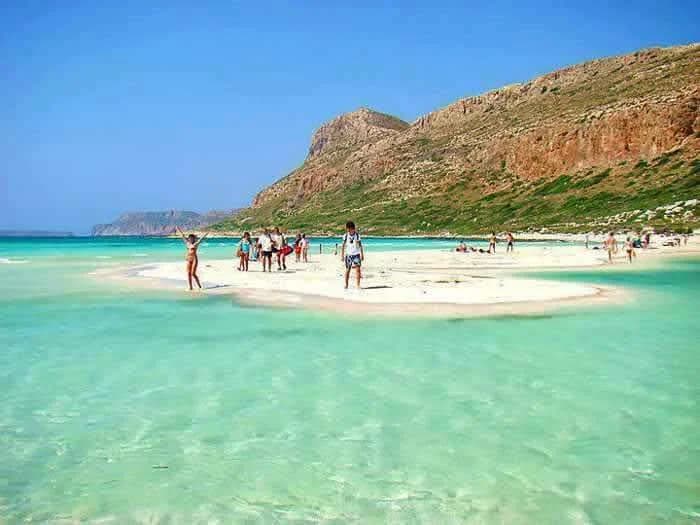 Looking down at the turquoise lagoons and white sands of Balos Beach from the steep hiking trail