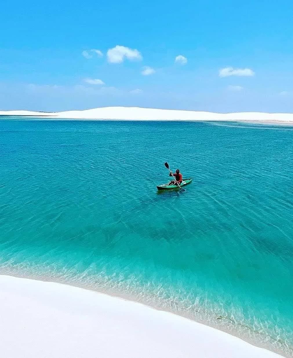 Boats docked along the calm river waters in the bustling hub of Barreirinhas
