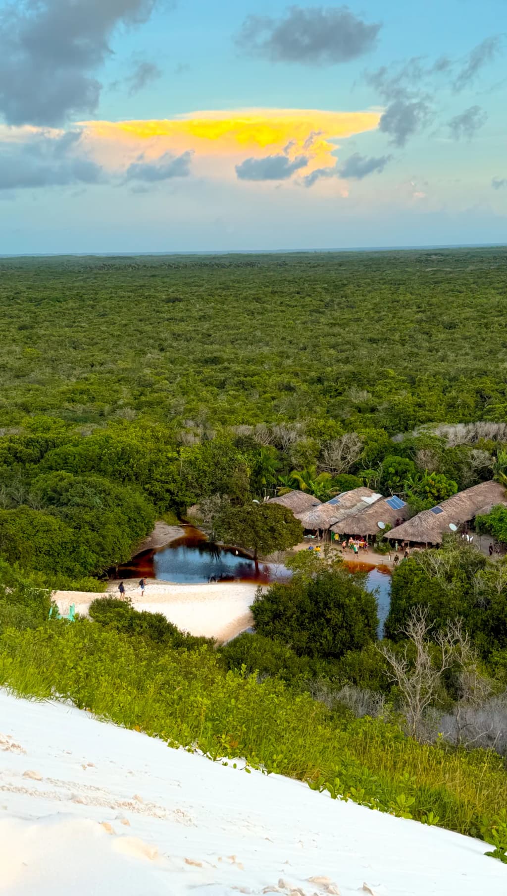 Golden hour light casting deep shadows across the sweeping dunes of Lagoa Bonita