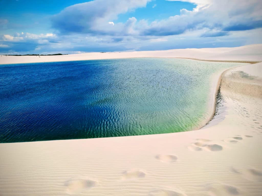 Stunning sunset over the vast dunes of Lagoa Bonita in Parque Nacional dos Lençóis Maranhenses