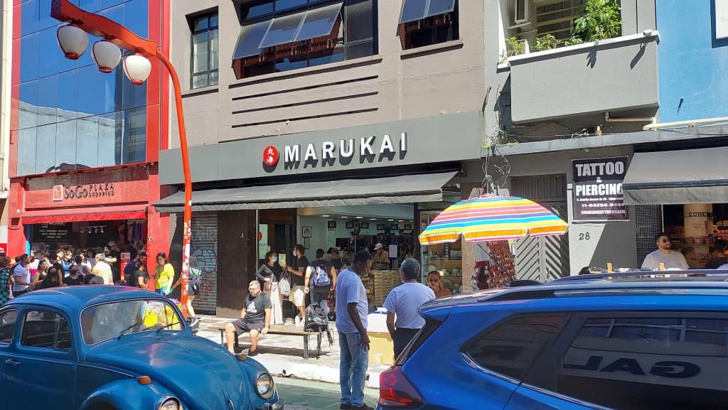 Shelves packed with imported Asian snacks and ingredients at a Liberdade emporium