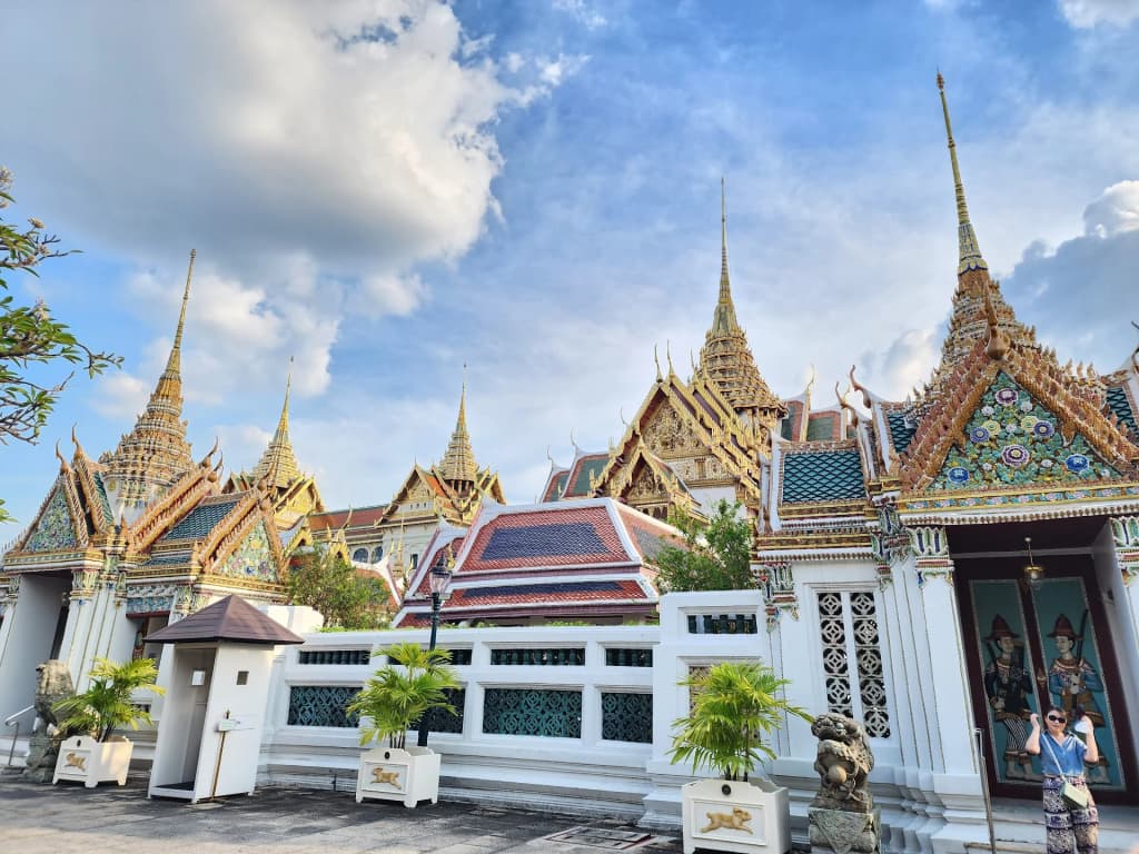 Intricate roof details and golden statues at The Grand Palace complex