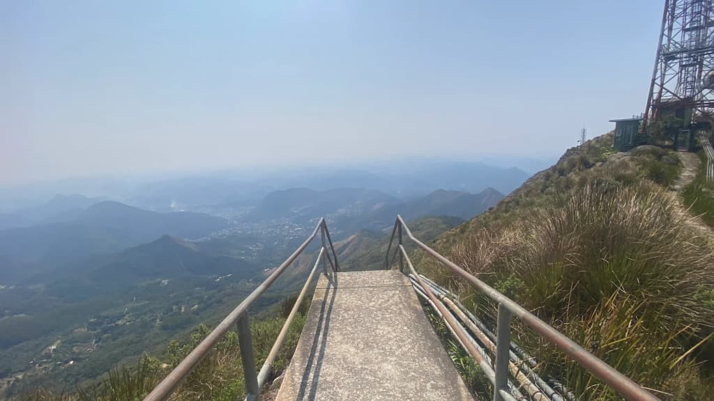 The rugged, cloud-swept peaks of Pico da Caledônia glowing in the early morning light