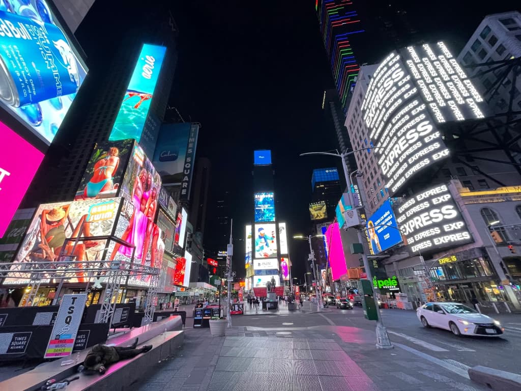 Neon lights reflecting off the wet streets of New York