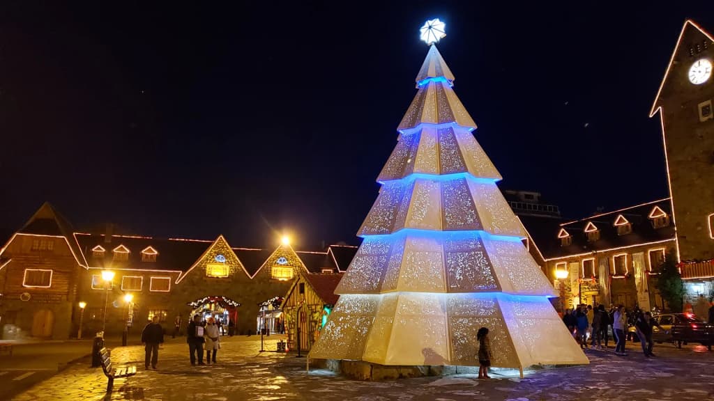 Snow-dusted pines framing the wooden buildings of Bariloche's downtown