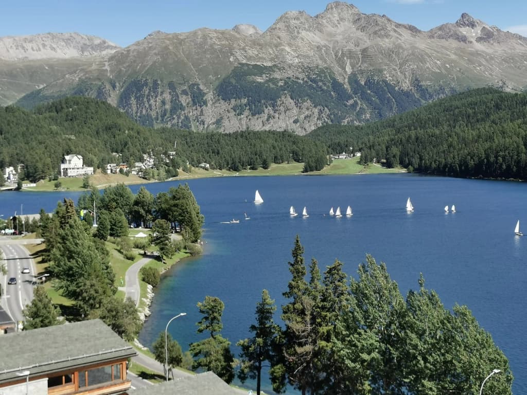 Walking across the completely frozen Lake St. Moritz surrounded by mountains