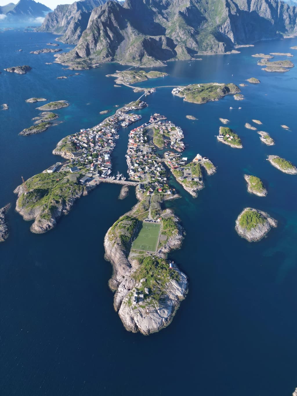 Lofoten Islands mountain landscape reflecting in water - Photo by متفائل•