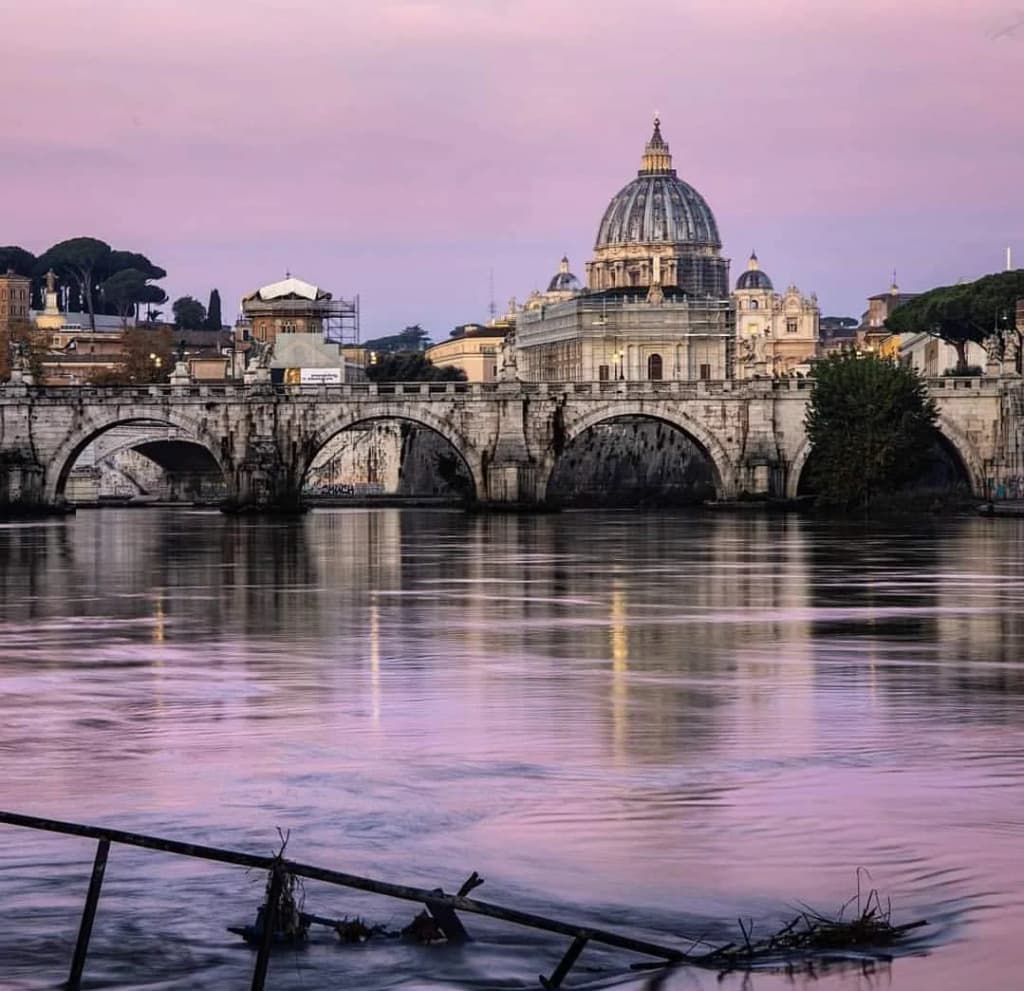 The Tiber River flowing past the imposing Castel Sant'Angelo