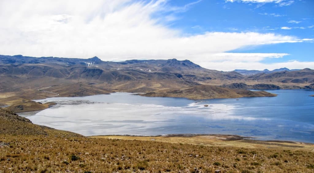 Morning mist rolling over the rugged peaks of the Peruvian Andes