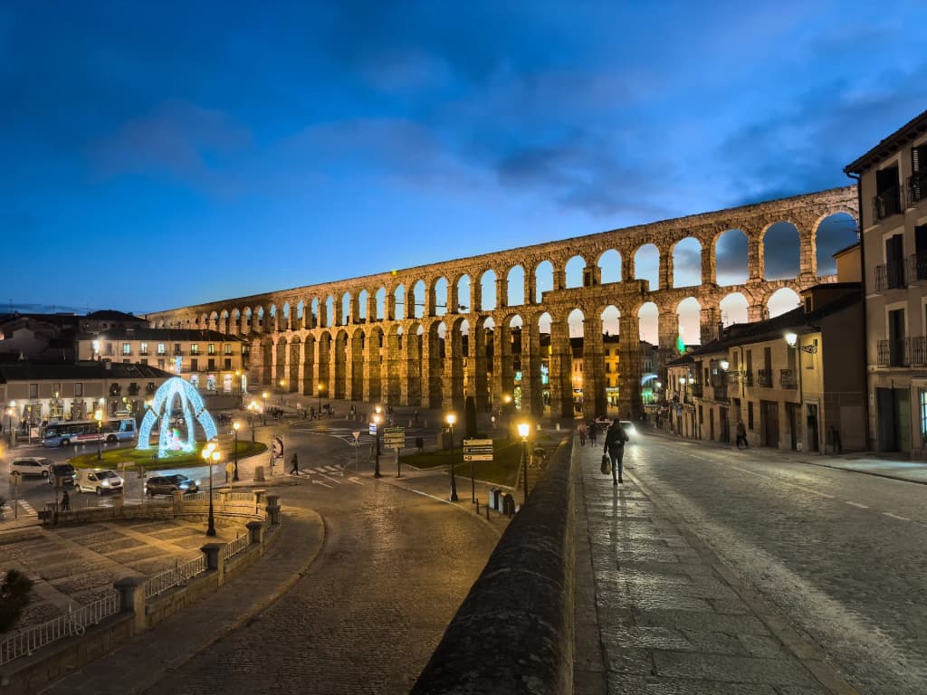 Sunlight hitting the ancient stone arches of the aqueduct