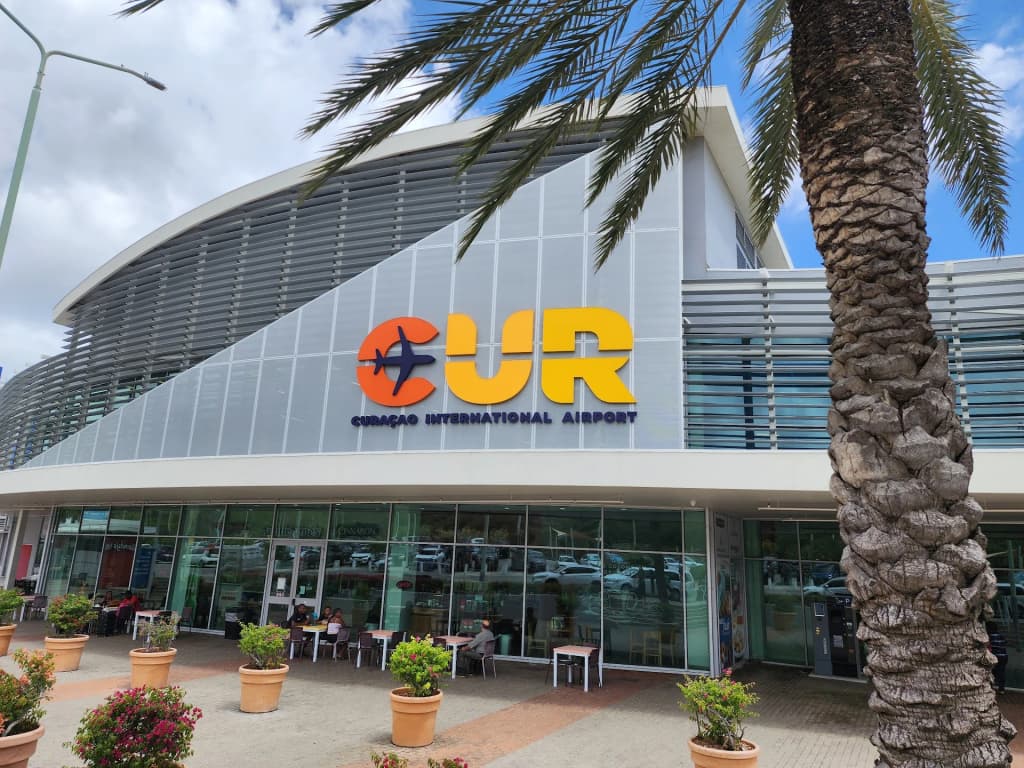 Travelers navigating the entrance of Curaçao International Airport