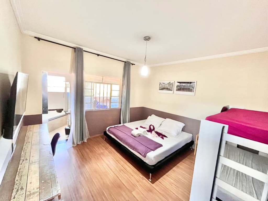 The striking modern architecture of Listra House framed by the lush, rolling mountains of Brumadinho