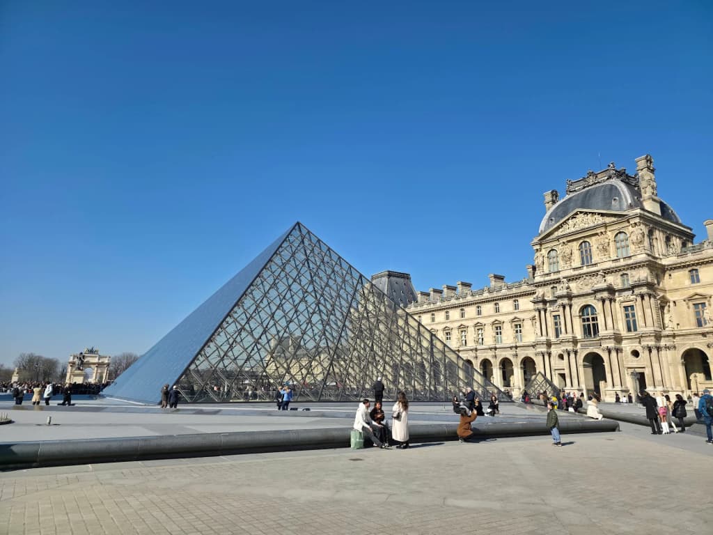 The timeless facade of the Louvre Museum catching the afternoon light