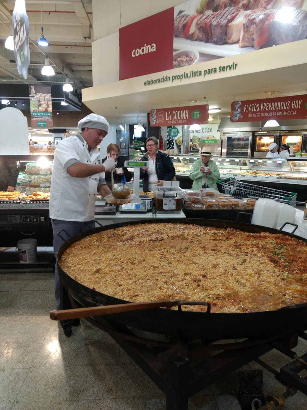 Shoppers navigating the brightly lit aisles of Jumbo supermarket in Palermo