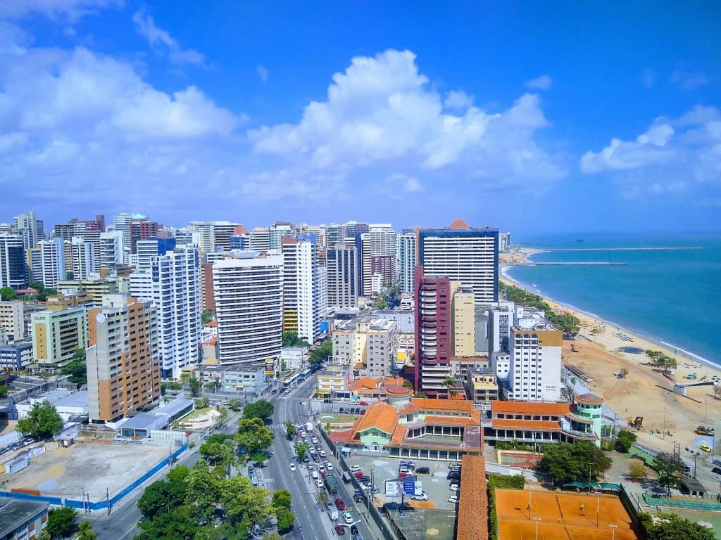 Cumbuco Beach at sunrise, with kite surfers and golden dunes