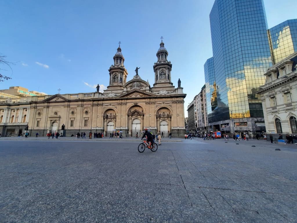 Pigeons scatter around the historic Plaza de Armas in downtown Santiago