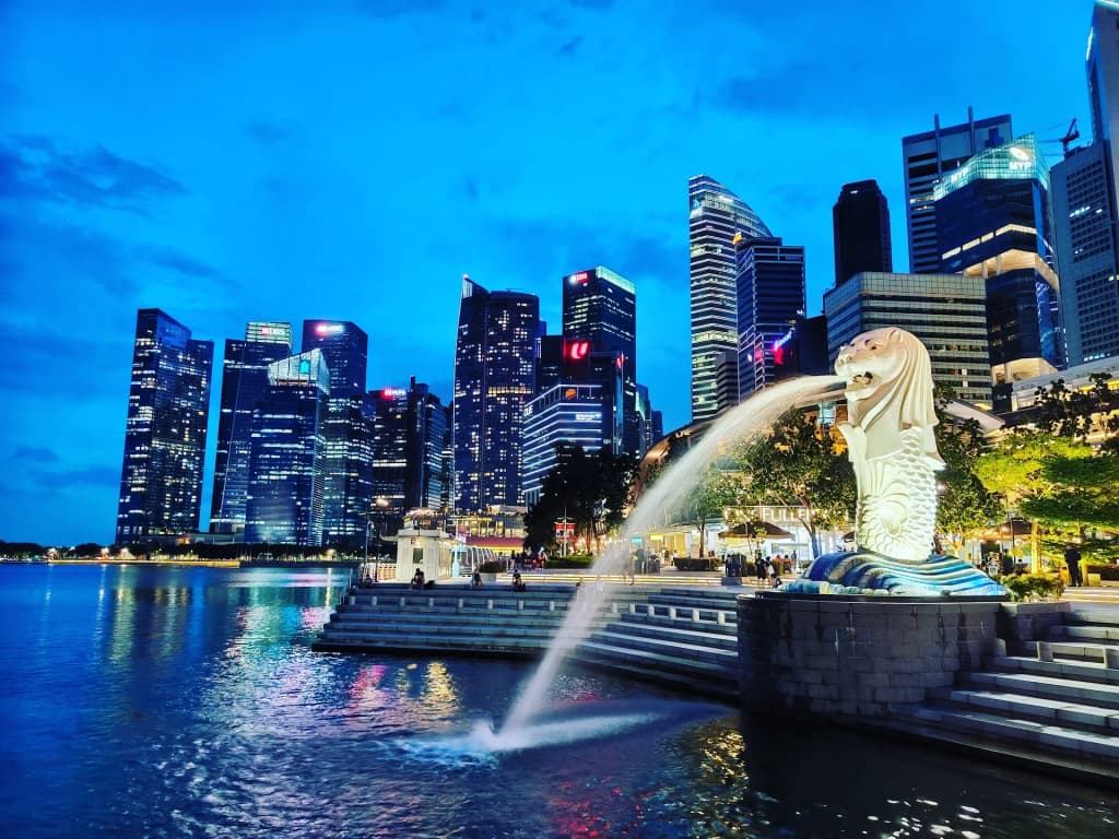 La icónica estatua del Merlion frente al skyline moderno de Marina Bay
