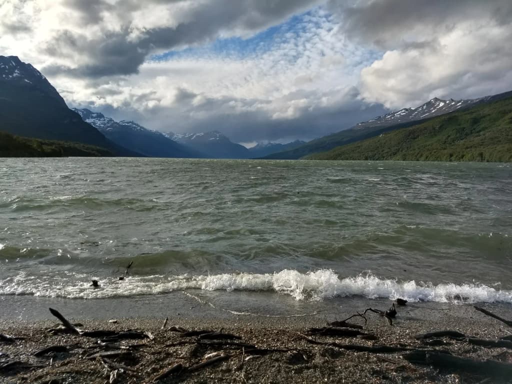 The wind-swept waters and dramatic Andean peaks of Lake Roca, also known as Lago Acigami