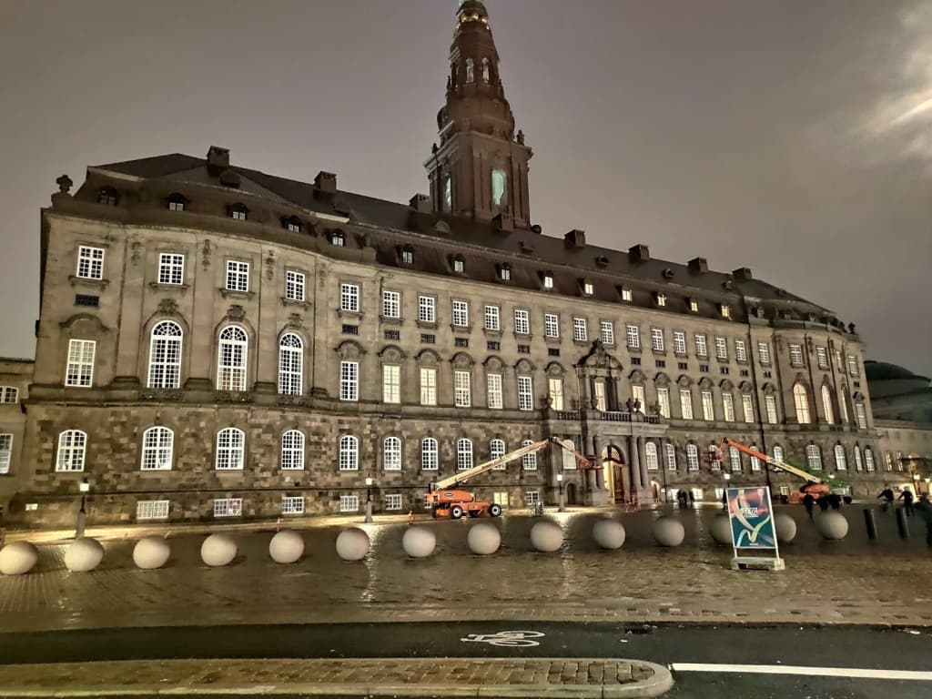 Sunny day at Nyhavn harbor with people dining outside