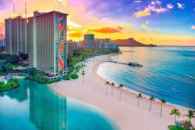 Surfers catching waves off Waikiki Beach in Hawaii