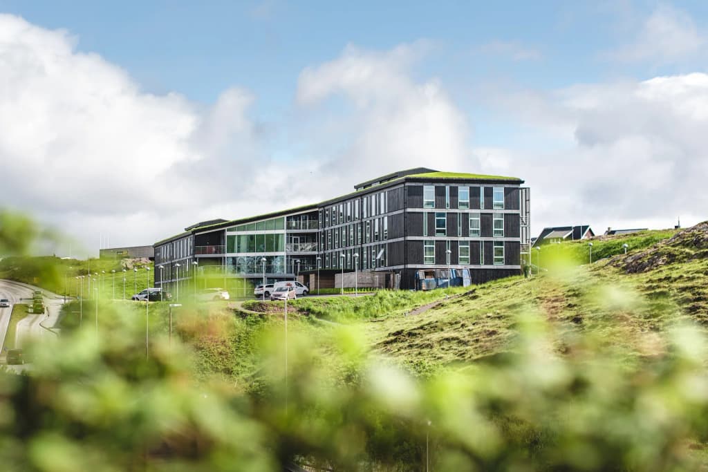 The glass facade and modern Nordic architecture of Hotel Brandan in Tórshavn