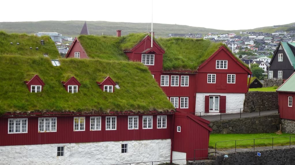Centuries-old wooden buildings with grass roofs in the historic Tinganes district of Tórshavn