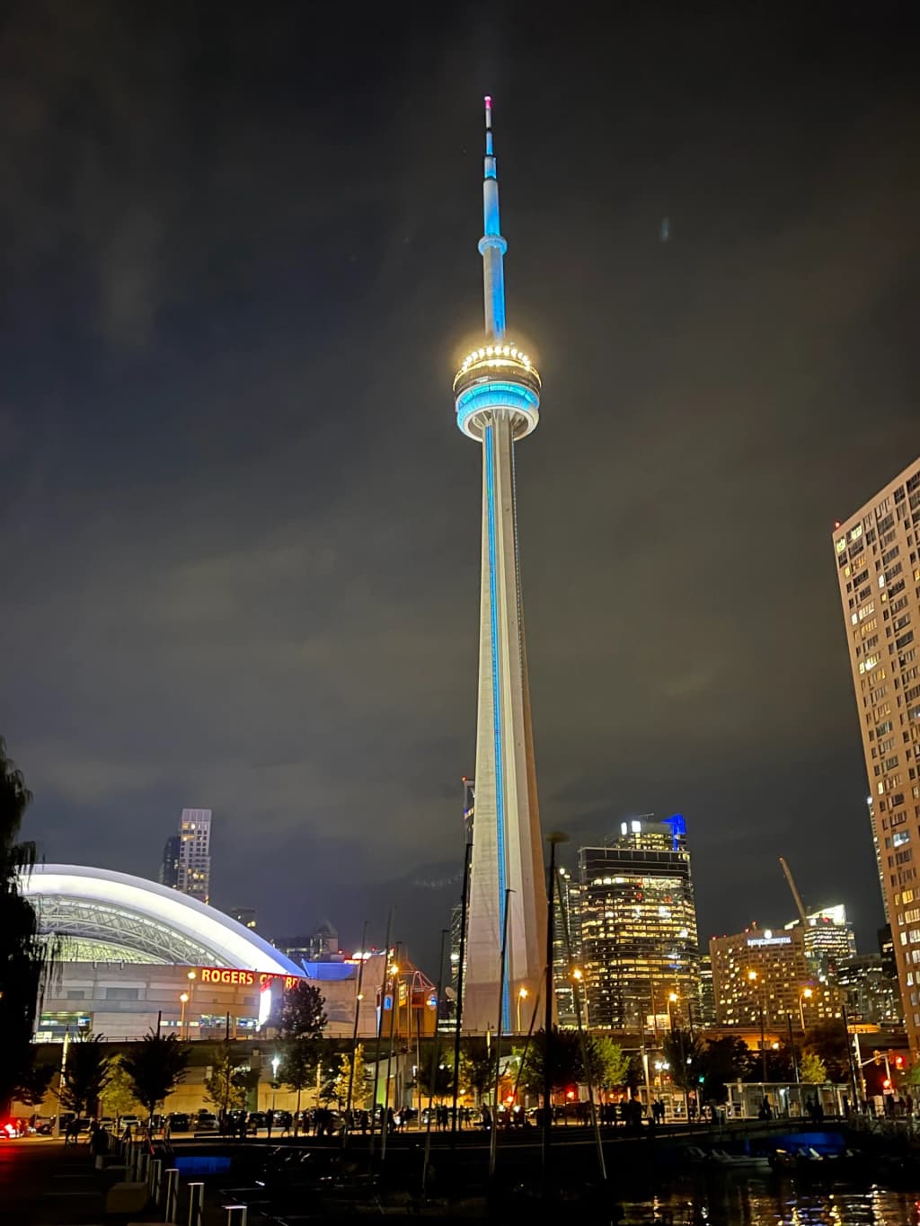 A distant view of the CN Tower framed by urban architecture