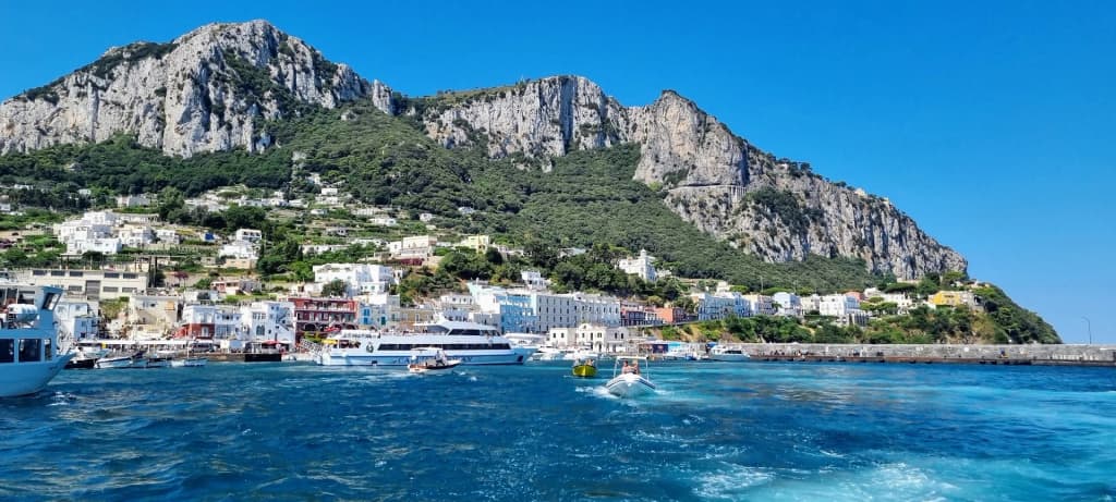 Boats anchored off the rocky coast of Capri