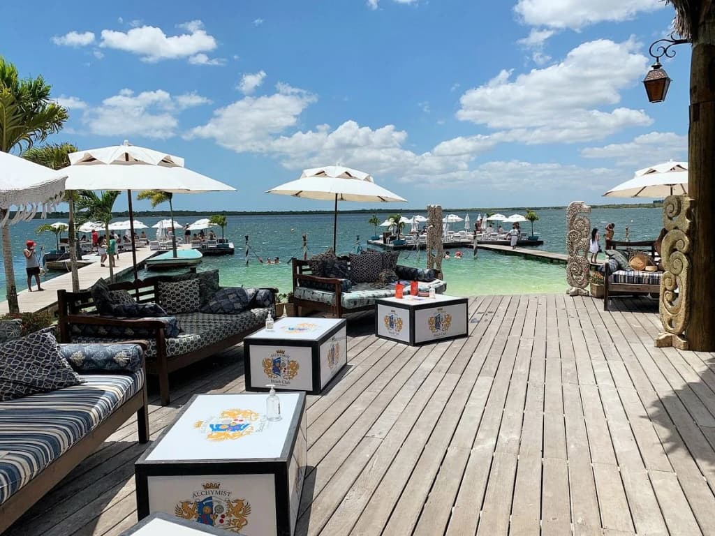 Crystal clear lagoon waters and lounging areas at Alchymist Beach Club