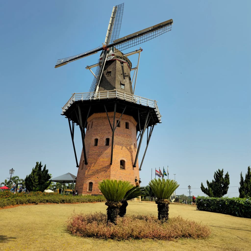 The towering Moinho Povos Unidos windmill rising above the Brazilian landscape in Holambra