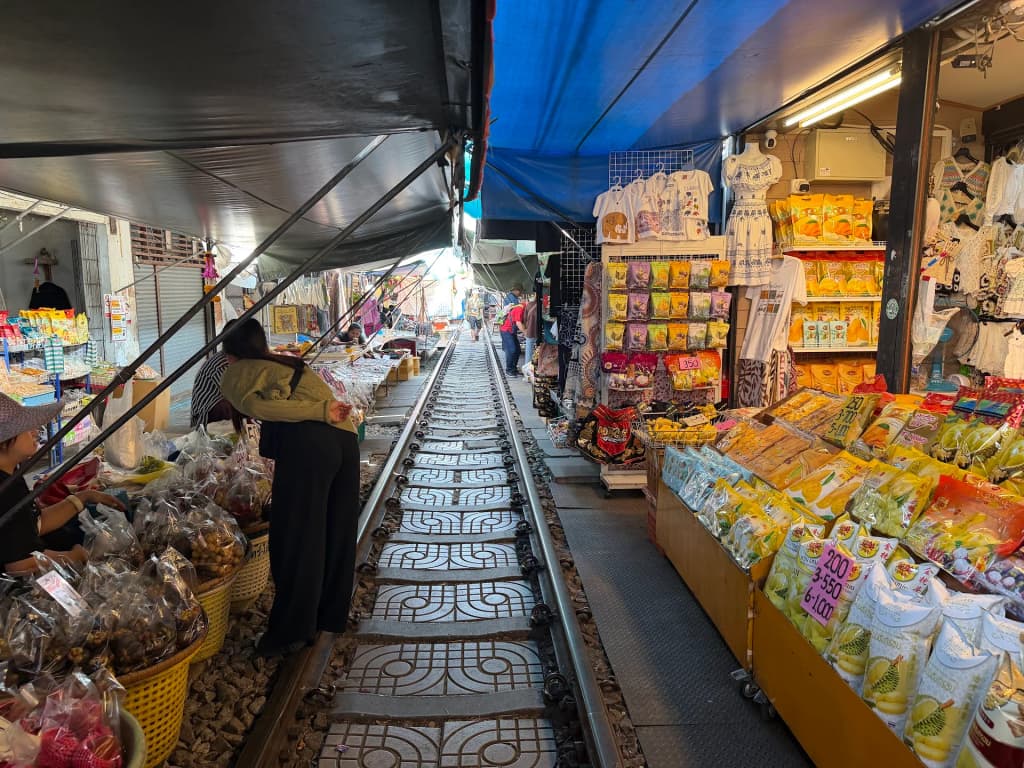 The train squeezing through the narrow market stalls