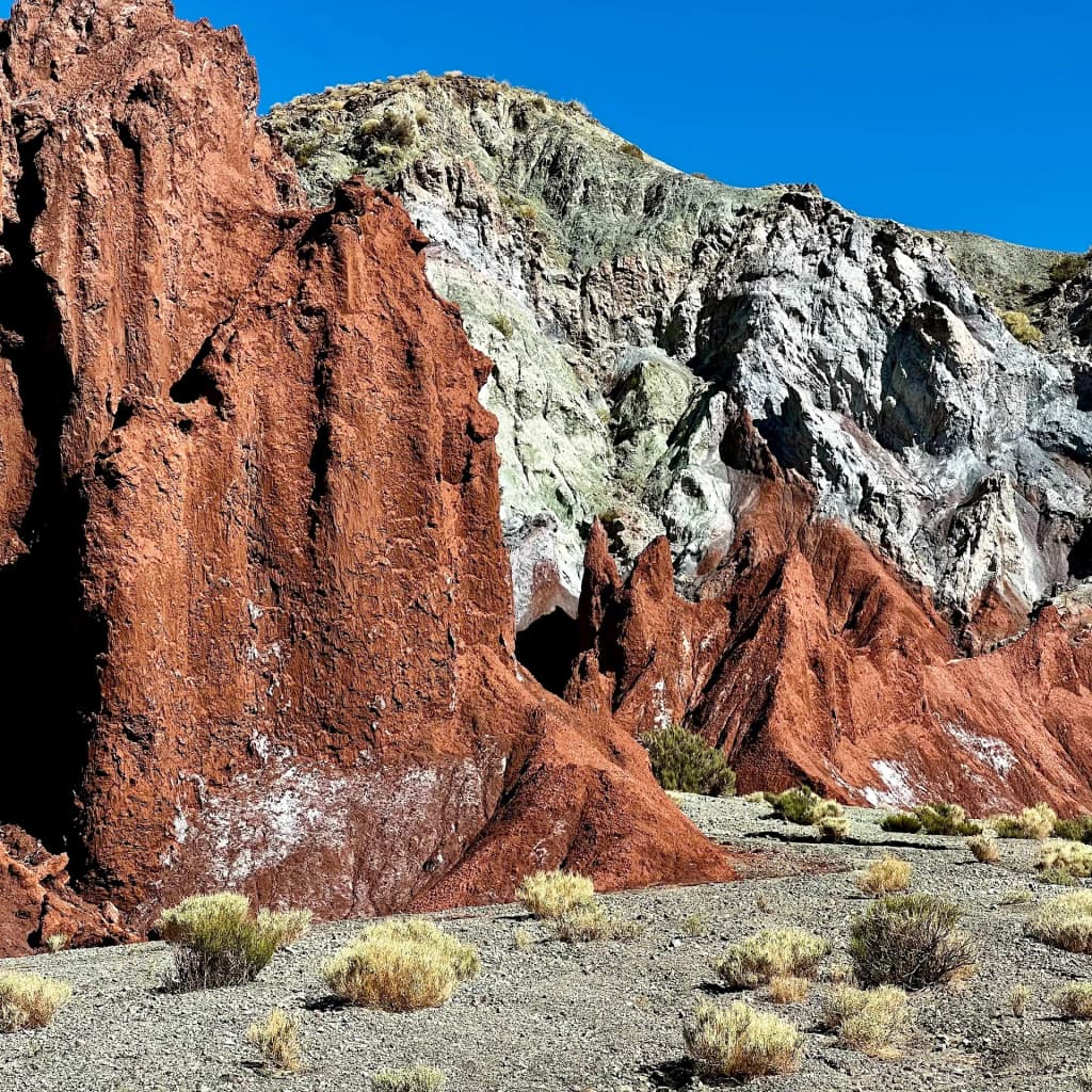 Striking red and green mineral rocks towering in Valle del Arcoiris
