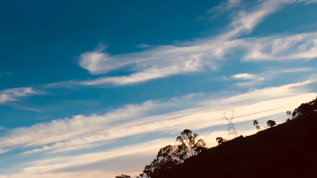 Hiker taking in the sweeping views from Pedra Branca viewpoint in Caçapava